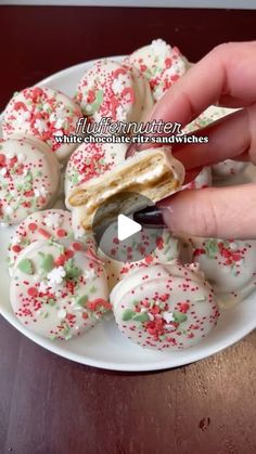 someone is cutting into some christmas cookies on a white plate with sprinkles