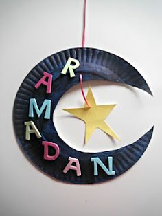 a paper plate with the word rama written on it and a crescent hanging from a string