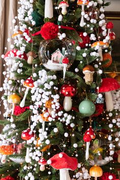 the christmas tree is decorated with red, white and green ornaments