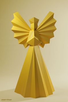 an artistic golden sculpture is displayed on a beige background