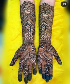 two hands with henna designs on them, one is showing the letter s and the other