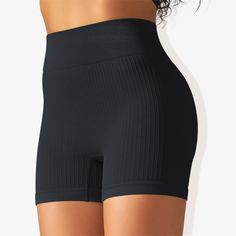 The Anna-Kaci Women's Wide Band Stretchy Rib Knit Seamless Gathered Biker Shorts are a must-have for your activewear collection. These shorts feature a wide band that offers a secure and comfortable fit, enhancing your silhouette with shaping seams. Made from stretchy rib knit fabric, they provide excellent flexibility and movement while maintaining a seamless construction for a smooth, irritation-free experience. The gathered detail adds a touch of style, making these biker shorts perfect for w High Stretch Black Shapewear Shorts, Black High Stretch Shapewear Shorts, Black Seamless Mid-thigh Bottoms, Black Bottoms With Seamless Construction And Short Leg, Black Stretch Shapewear Biker Shorts, Black Stretch Biker Shorts Shapewear, Black Breathable Bottoms With No Elasticity, Black Compression Bottoms In Seamless Fabric, Black Seamless Workout Shorts