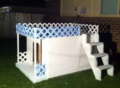 an outdoor play structure made out of cardboard and painted white with blue lattice design on the top