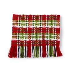 a red, white and green blanket with fringes