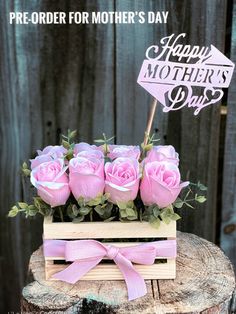 a wooden box with pink roses in it and a happy mother's day sign