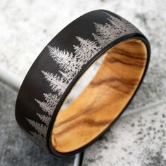 a wood and metal ring with trees on it