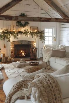 a living room filled with furniture and a fire place covered in christmas lights next to a fireplace