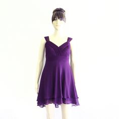 a mannequin dressed in a purple dress