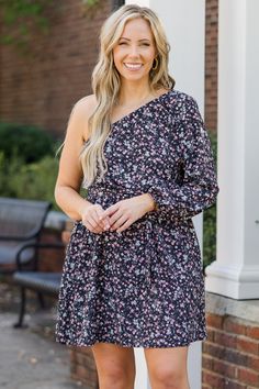 Get ready to dance the night away in this dress! This dress features a playful fit and flare silhouette, perfect for twirling on the dance floor! The one shoulder design adds a touch of flirtiness, while the ditsy floral print adds a fun and feminine touch! Don't miss out on this must-have for your summer wardrobe! 100% Polyester Black One-shoulder Evening Dress For Spring, Black One Shoulder Mini Dress For Spring, Flowy One-shoulder Dresses With Floral Print, One Shoulder Floral Print Dress For Night Out, Flirty One Shoulder Mini Dress With Floral Print, Black One-shoulder Mini Dress For Spring, Flowy One-shoulder Floral Print Dress, Flowy Mini Dress With Sweetheart Neckline And Floral Print, Flirty One-shoulder Floral Print Dress