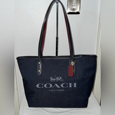 Nwot- This Coach Tote Is Comparable To The Size Of The Lv Neverfull Mm. It’s Lightweight And Has Comfortable Leather Shoulder Straps. The Inside Has Compartments For Organization And A Top Zip Closure. The Bottom Is Leather For Extra Durability. It Has Been Stored Filled In Its Original Dust Bag. The Bags Canvas Has Been Treated For Protection. Will Very Comfortably Fit 13” Macbook Air And Zip With Room To Spare. Bottom Width 12” Top W 16” X 10”H X 5”D (17” Diagonal) 10” Handle Drop Blue Coated Canvas Bags With Branded Hardware, Coated Canvas Shoulder Bag With Branded Hardware For Errands, Coated Canvas Shoulder Bag For Errands With Branded Hardware, Branded Hardware Everyday Tote Bag, Branded Hardware Tote Bag, Tote Bag With Branded Hardware, Everyday Tote Bag With Branded Hardware, Coach Coated Canvas Bag For On-the-go, Coach Bags With Large Capacity For Daily Use