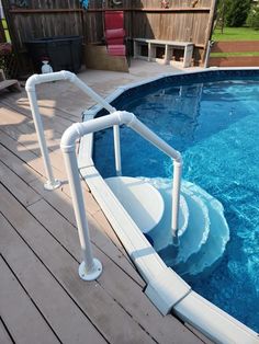 an above ground swimming pool with railings around the edge and water running down it