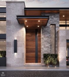 the front entrance to a modern house with wood and stone sidings, lit up at night