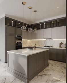 a large kitchen with marble counter tops and gray cabinetry, along with pendant lights