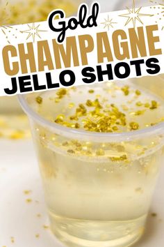 champagne jello shots with gold sprinkles in a clear plastic cup on a white surface