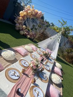 a table set up for a party with plates and napkins on top of it