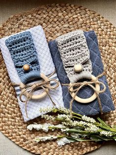 two crocheted napkins with wooden handles on a woven place mat next to flowers