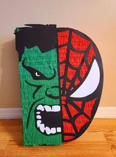 a paper mache with a spiderman face on it's front and back sides