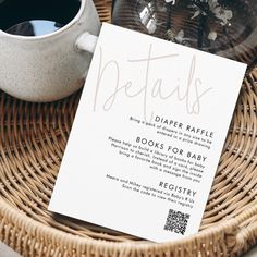 a close up of a menu on a table near a cup of coffee and a vase with flowers