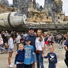 a family poses for a photo in front of the star wars galaxy at disney world