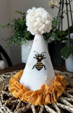 a white hat with a bee on it