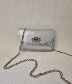 Bag Dimension: Hx15cm Wx22cm Dx7cm Chain Strap full length is 122cm Specification: Twist lock Closure Silver tone metal Hardware Detachable strap Material: Real Leather Silver Crossbody Evening Bag With Chain Strap, Silver Crossbody Evening Bag, Silver Shoulder Bag For Party, Silver Mobile Phone Shoulder Bag For Party, Gift Satchel Evening Bag With Chain Strap, Chain Strap Satchel Evening Bag Gift, Trendy Silver Evening Bag With Phone Holder, Evening Satchel Bag With Chain Strap As A Gift, Trendy Silver Crossbody Clutch