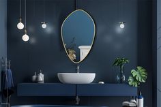 a bathroom with a blue tub, sink and mirror