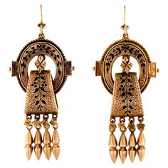 This outstanding pair of Victorian circa 1865 14kt yellow gold and black enamel tracery long pendant drop earrings of fine detail is simply fabulous. Three dimensional - floral engraved gold with applied gold details all embellished with black enamel tracery convex spheres of gold dangle from the ends of the earrings - Absolutely stunning earrings Excellent condition - measures approximately 2.00" Length (not including gold wires) and 7/8" + at widest. Traditional 14k Gold Drop Earrings, Traditional Black Filigree Jewelry, Luxury Filigree Dangle Jewelry, Luxury Dangle Filigree Jewelry, Elegant Black Enamel Dangle Jewelry, Victorian Pierced Jewelry For Ceremonial Occasions, Yellow Gold Enamel Dangle Earrings, Elegant Oval Enamel Jewelry, Elegant Black Enamel Drop Earrings