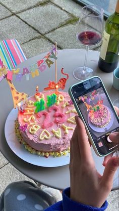 a person taking a photo of a birthday cake on their cell phone with the app