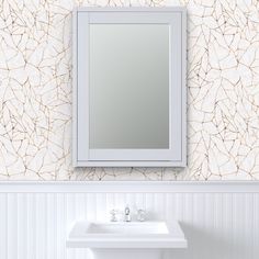 a white sink sitting under a bathroom mirror next to a wall mounted faucet