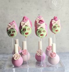 there are four candy lollipops with faces on them