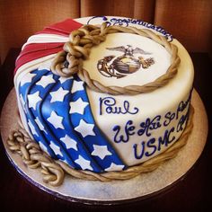 a cake decorated with american flags and marine emblems