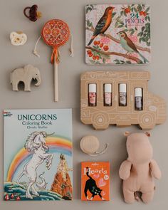 an assortment of children's books and toys on a table with the contents laid out