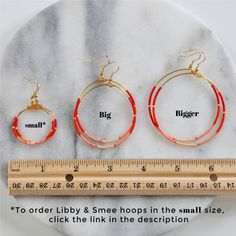 You asked for bigger beaded hoops and Libby & Smee answered! These dangly hoop earrings are the pieces you'll grab every day when you want a little something fun without a lot of fuss. Bonus: They look great dressed up or super casual. beaded hoops with tiny glass seed beads style: OMBRE — red, orange, peach and pale blush with gold available in two large sizes: BIG, a teardrop shape approximately 1.75 inches wide and 2.75 inches long, or BIGGER, a circle shape 2.25 inches wide and 3 inches long Red Ombre, Beaded Hoops, Circle Shape, Beaded Earrings, Seed Beads, Hoop Earrings, Beads, Pattern, Red