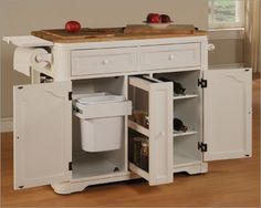 a white kitchen island with an open door and two bins on the bottom shelf