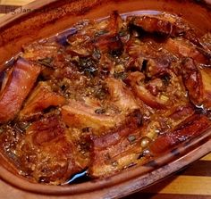 the dish is full of meat and vegetables on the wooden tableclothed placemat