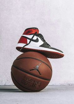 a pair of shoes sitting on top of a basketball