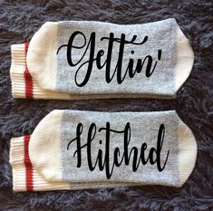 two pairs of socks that say, gettin's hitched and have red stripes on them