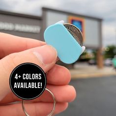 a person holding a coin in their hand with the words 4 colors available on it