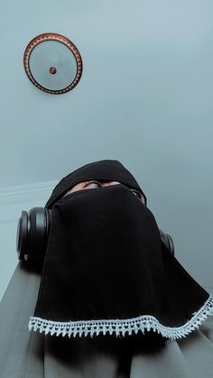 a person wearing a black head covering with white trim