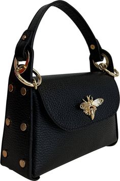 L'Abeille Bag Color: black Material: leather Made in Italy Dimensions: 6" H (excluding handle) x 7.25" W at the base, 2.25" D at the base Handle length: 4.5" from top of bag to top of handle, 9.5" from right to left Chain strap length: 110 cm (43.3") L'Abeille is french for bee. We have a love for bees and will find pieces that embody our bee love. Top Handle Satchel With Handles As Fashion Accessory, Elegant Leather Satchel Fashion Accessory, Luxury Black Evening Bag With Metal Hardware, Black Bag With Round Handles, Black Shoulder Bag With Gold-tone Hardware And Round Handle, Leather Bags With Round Handle For Gifts, Satchel With Detachable Top Handle, Black Double Handle Evening Bag With Top Carry, Black Evening Satchel With Metal Hardware