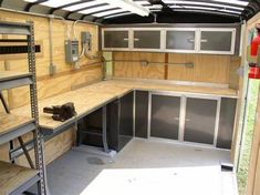 the inside of a truck with shelves and cabinets on it's sides, including ladders