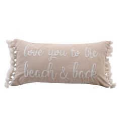 the love you to the beach and back pillow with pom poms on it