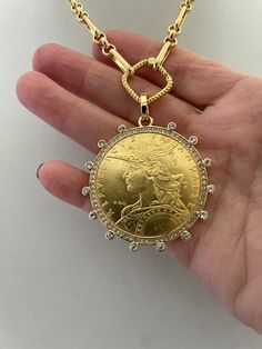 Beautiful reproduction vintage coin pendant, French Madagascar coin in a bezel with cubic zirconia stones. The bale attached to the coin is also encrusted with CZ stones. The coin is 22k gold plated and elegantly hangs from a multi link gold plated brass chain and a rope design spring lock clasp. The spring lock closure not only makes it easy to open and close the necklace for those with difficulty but adds to the creativity of the jewelry piece. Please see photograph of how to open the clasp. W Gold Coin Necklace, Rope Design, Gold Coin, Coin Necklace, Coin Pendant, Keep Jewelry, Gold Coins, Brass Chain, Chain Link Necklace