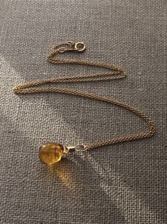 The medium shade of amber has a warm golden richness to it, which is calm, soothing and very pleasant to the eye.   Each Czech glass briolette is approximately 10 x 14mm in size.  I have Made the loop hole of the pendant to be approximately 4-5mm in size.  The pendant is approximately 20mm in length in total. Gold filled chain necklaces are available, you can choose your desired length of chain necklace from the drop down menu or simply buy the pendant by its self.  So what is gold filled? The a Chain Necklaces, Pendant Gold, Organza Gift Bags, Earrings Photo, How To Make Earrings, Gold Filled Jewelry, Amber Glass, Gold Filled Chain, Teardrop Earrings