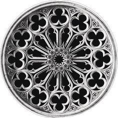 an ornate metal plate with hearts in the center and four leaves at the bottom, on a white background