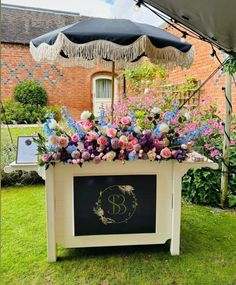 a table with an umbrella and flowers on it