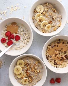 four bowls of oatmeal with bananas and raspberries on the side