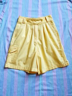 + super cute vintage eighties bright yellow camp shorts with flattering pleats & fun pocket details + ultra high waisted rise, roomy pant legs, & cinched waist, with belt loops for easy accessorizing & cool crossover double snap closure + the front features small pleats tucked into the waistband & two front pockets; the back has two pockets with envelope flap snap closure; the right leg has an extra envelope flap snap pocket on the side + the color is a bit brighter/more of a classic banana yell Banana Yellow, Pocket Shorts, Yellow Plaid, Pleated Shorts, Brand Tags, Cinched Waist, Vintage Baby, Shorts With Pockets, Bright Yellow