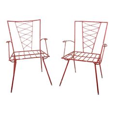 two red metal chairs sitting next to each other