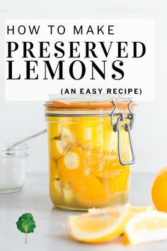 a jar filled with lemons sitting on top of a table next to sliced lemons